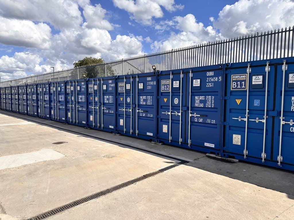 A row of blue shipping containers with locking mechanisms in Sheffield
