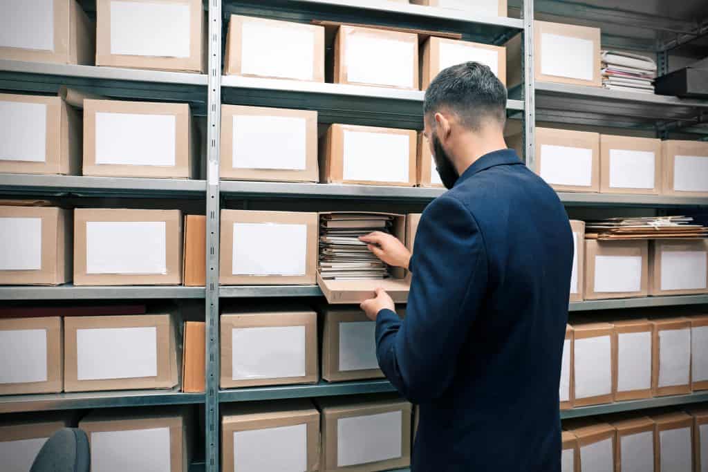man sorting out archives in self storage